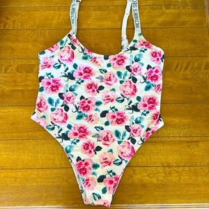Victoria’s Secret white swimsuit with pink flowers.  Very high cut legs. Size XL